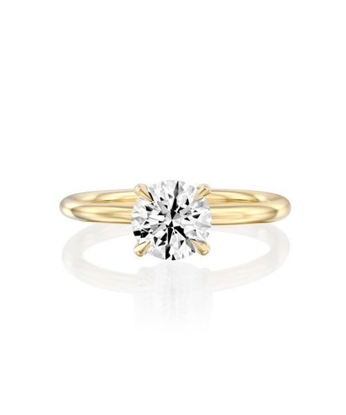 Lustrous Solitaire: 1.3 CT Round Brilliant Engagement Ring in Yellow Gold